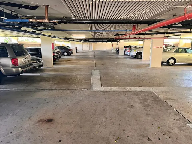 a view of parking garage with cars