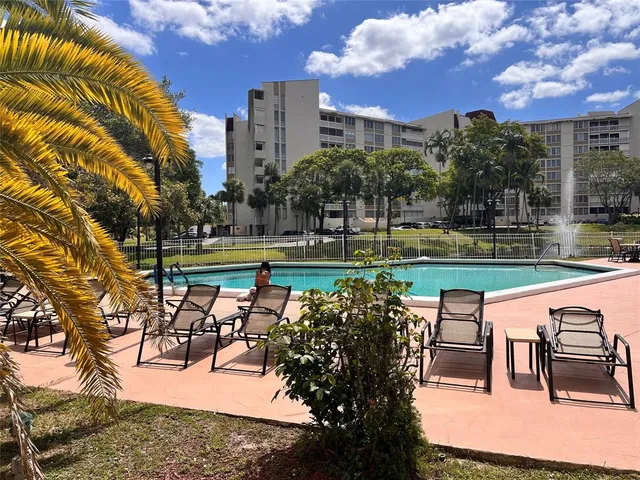 a view of a lake with a table and chairs