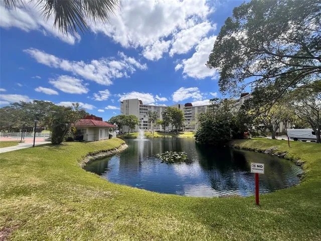 a view of a swimming pool with a patio and a yard