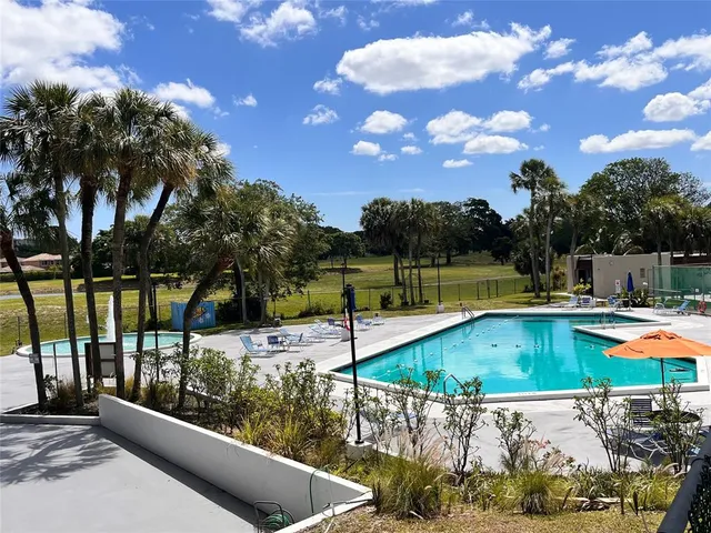 a view of a swimming pool with a lounge chairs