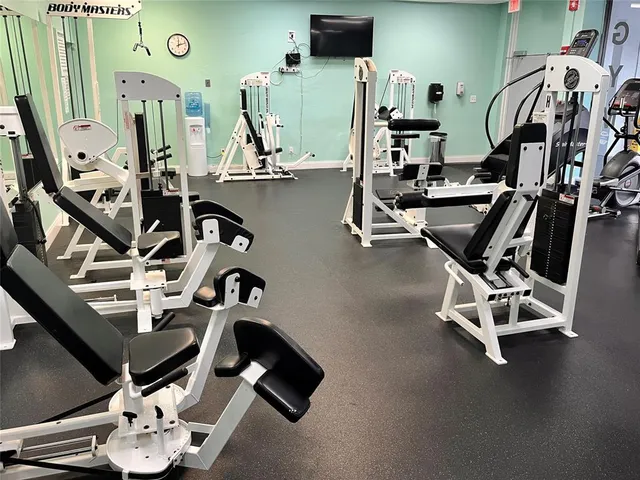a living room with furniture and large windows