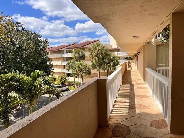 a view of balcony with wooden floor and fence