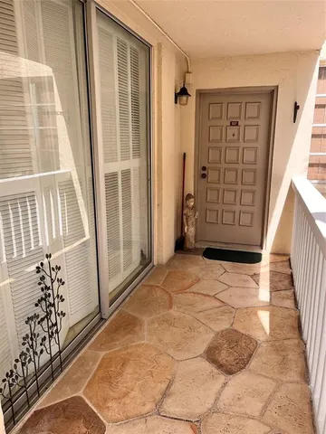 a view of an entryway with wooden floor and door