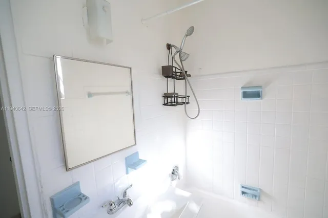 a bathroom with a bathtub and shower