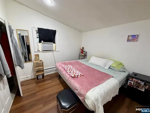 a bedroom with a bed and flat screen tv