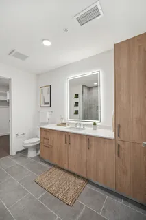 a large bathroom with a double vanity sink a mirror and a bathtub