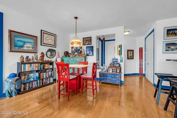 a dining room with furniture and wooden floor