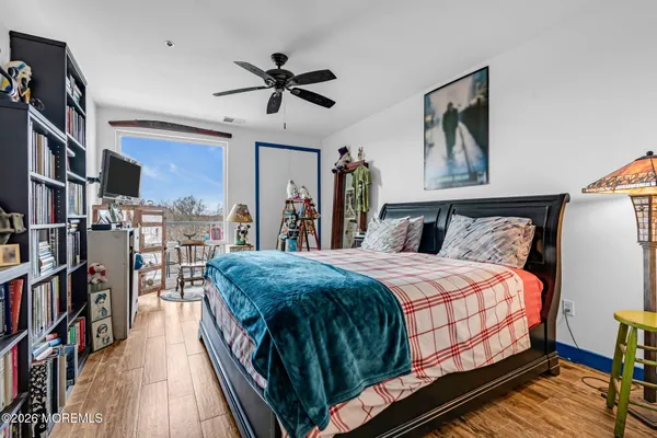 a bedroom with a large bed and a chandelier
