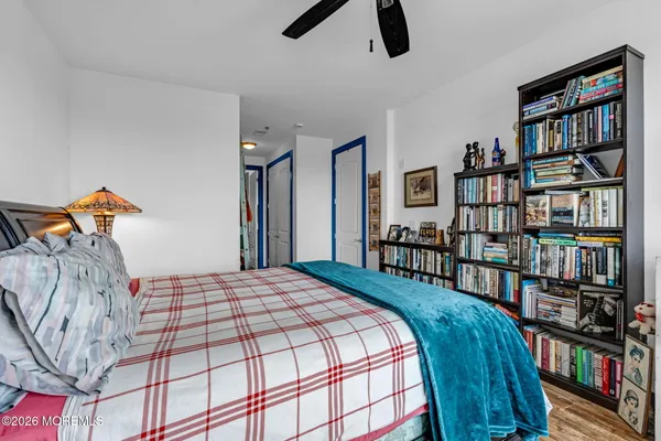 a bedroom with a bed furniture and a book shelf