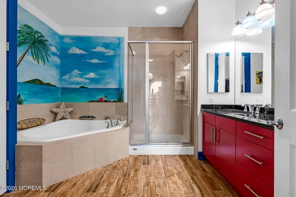 a bathroom with a sink a mirror and a shower
