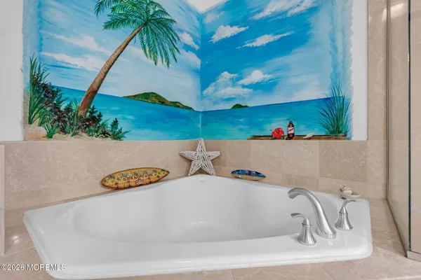 a bathroom with a bathtub and a potted plant
