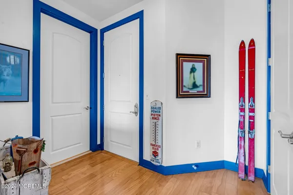 a view of a bedroom with wooden floor and closet