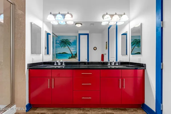 a bathroom with a granite countertop sink and a mirror