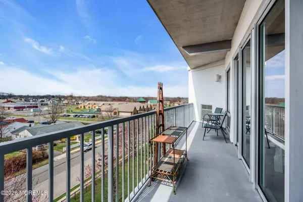 a terrace with outdoor seating and trees