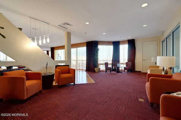 a room with lots of chairs and wooden floor