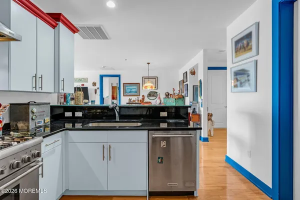 a kitchen with stainless steel appliances granite countertop a stove and a sink