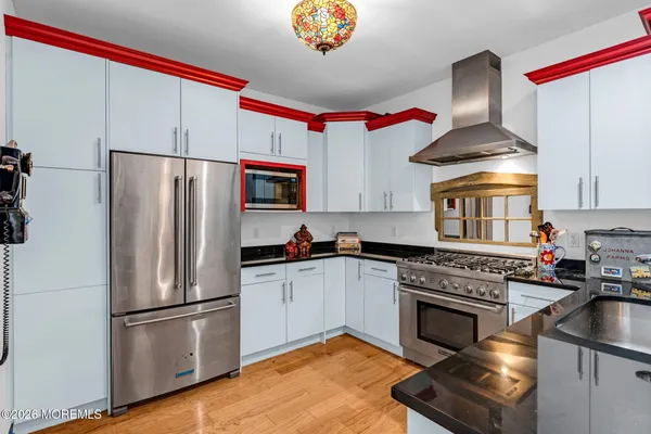 a kitchen with stainless steel appliances granite countertop a stove a refrigerator and a sink