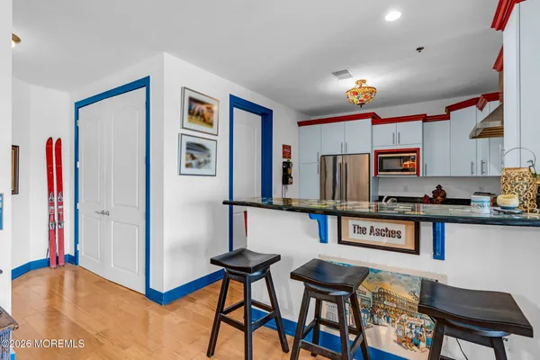 a kitchen with stainless steel appliances granite countertop a refrigerator and a stove top oven