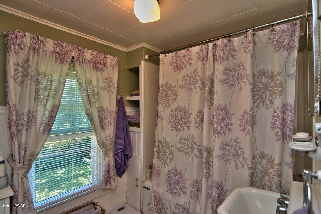 72 Hemlock Road Lake Ariel, PA 18436 - Photo 45 of 48 a bathroom with a shower curtain and a large window