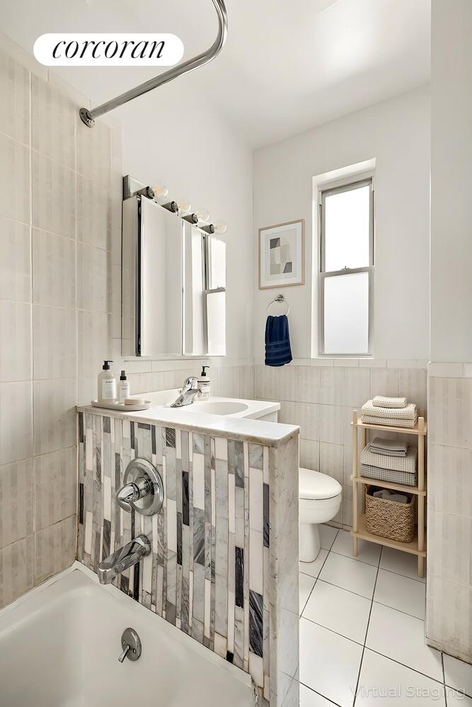 415 9th Street, Unit 51 Brooklyn, NY 11215 - Photo 4 of 6 a bathroom with a sink a toilet and a bathtub