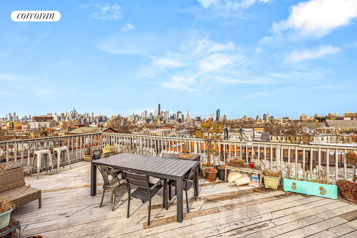 415 9th Street, Unit 51 Brooklyn, NY 11215 - Photo 5 of 6 a view of a rooftop deck with chairs and wooden floor
