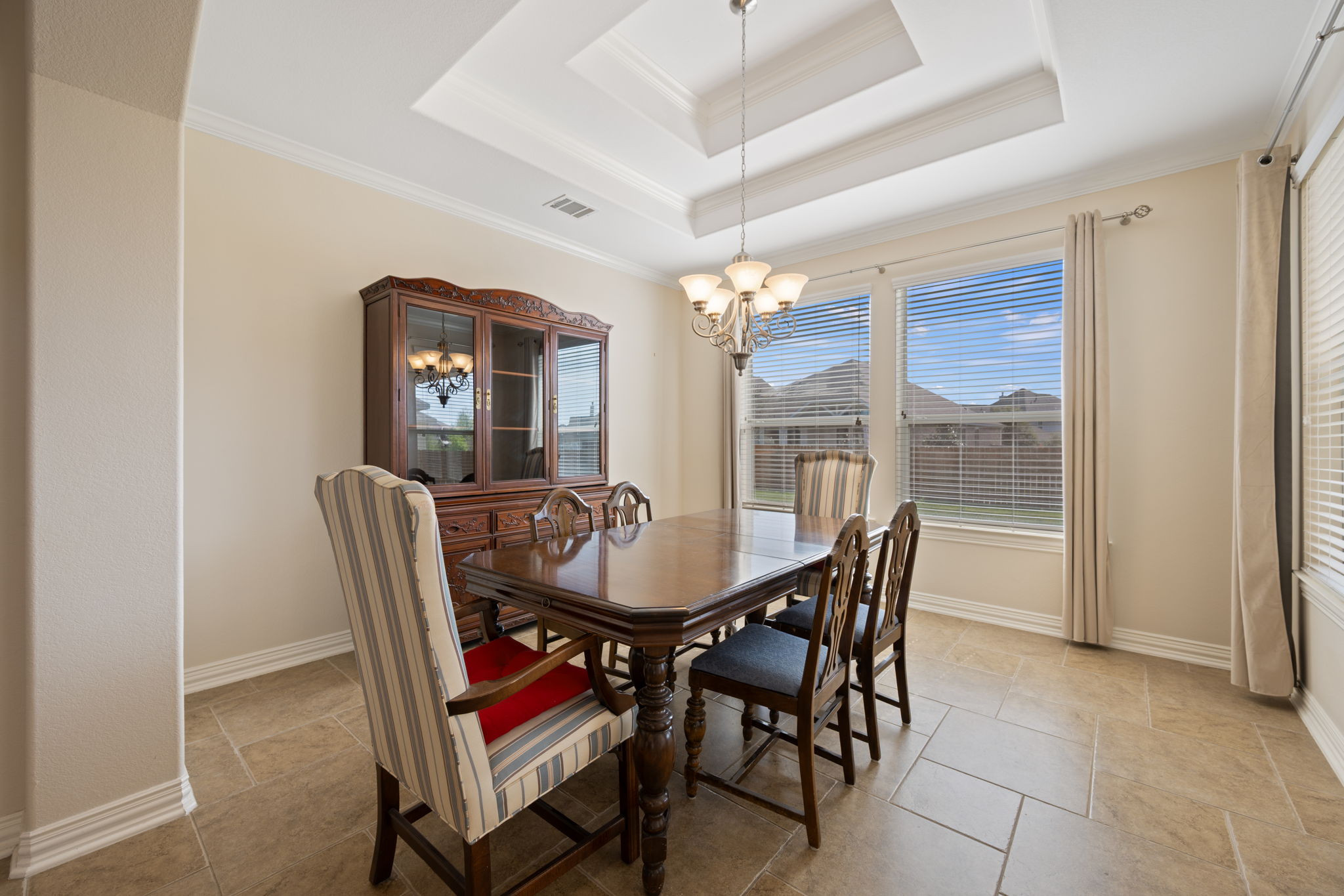 3904 Brean Down Road Pflugerville, TX 78660 - Photo 12 of 40 Dining room featuring hanging lights, crown molding, and a raised ceiling
