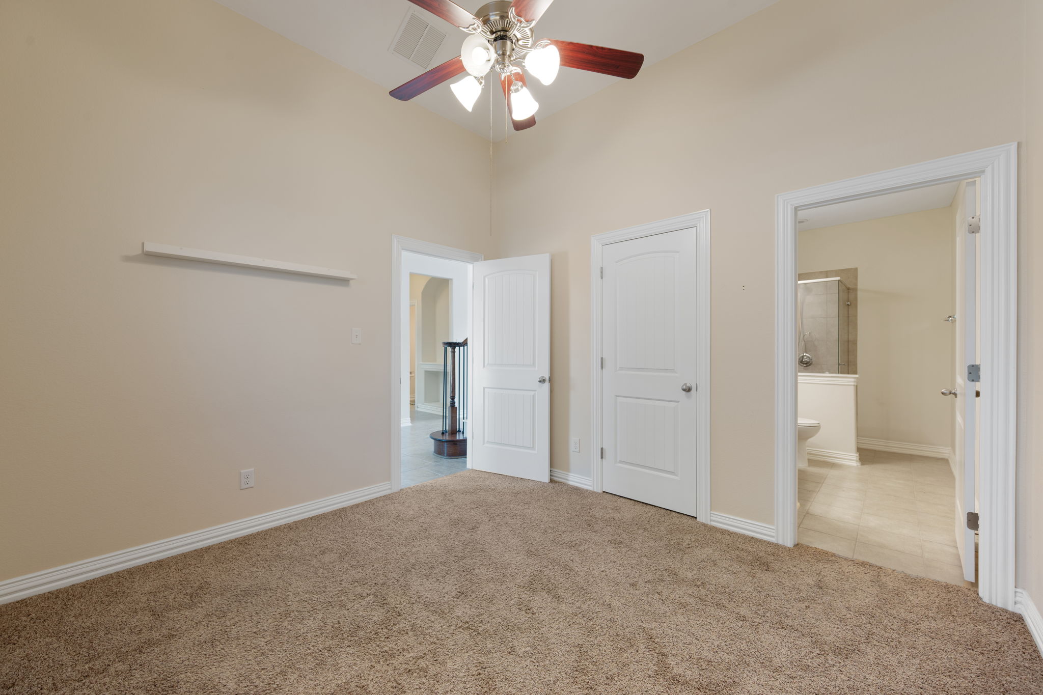 3904 Brean Down Road Pflugerville, TX 78660 - Photo 19 of 40 Unfurnished bedroom featuring light colored carpet, a ceiling fan, ensuite bathroom, and a closet