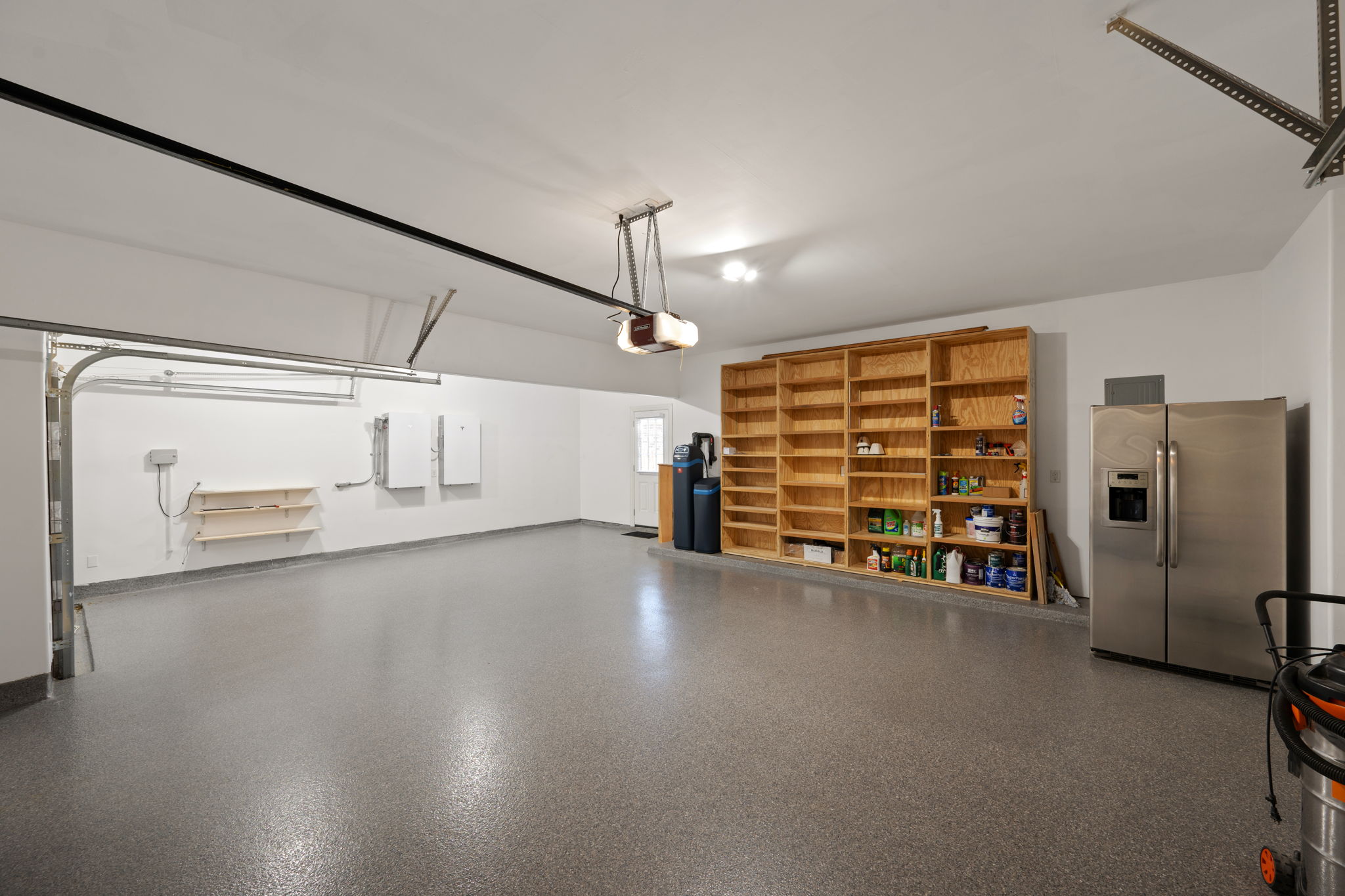 3904 Brean Down Road Pflugerville, TX 78660 - Photo 32 of 40 Garage with stainless steel fridge with ice dispenser and baseboards
