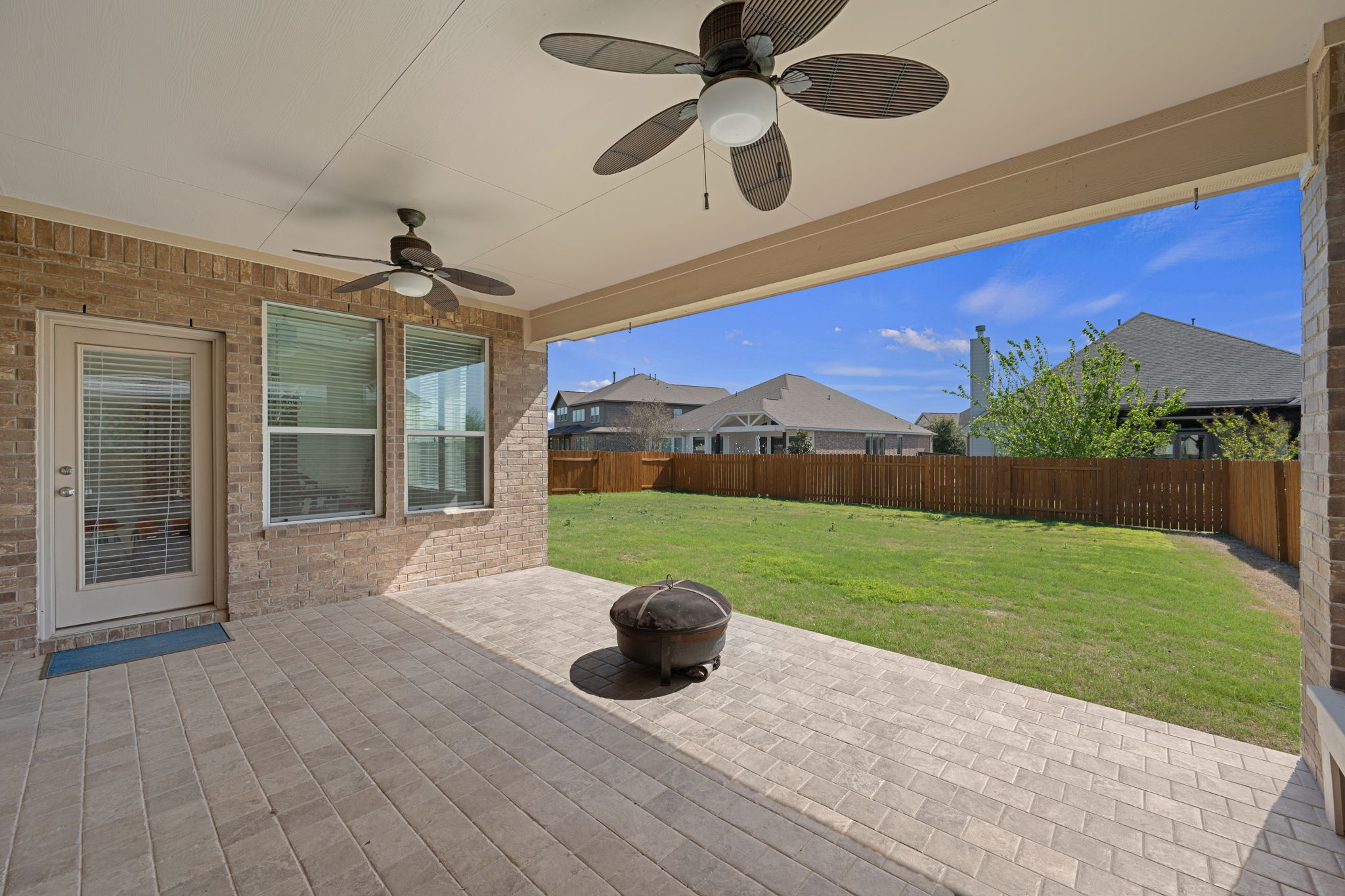 3904 Brean Down Road Pflugerville, TX 78660 - Photo 35 of 40 Fenced backyard with a ceiling fan, a patio, and an outdoor fire pit