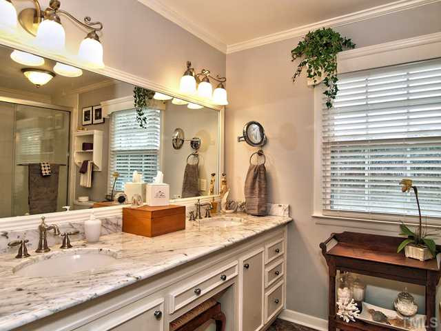 5301 Pelham Road Durham, NC 27713 - Photo 15 of 25 a bathroom with a granite countertop sink and a mirror