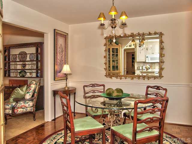 5301 Pelham Road Durham, NC 27713 - Photo 8 of 25 a view of a dining room with furniture and chandelier