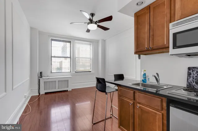 a kitchen with stainless steel appliances granite countertop a sink stove and microwave