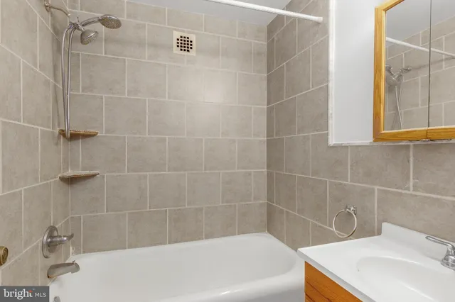 a bath tub sitting next to a white sink