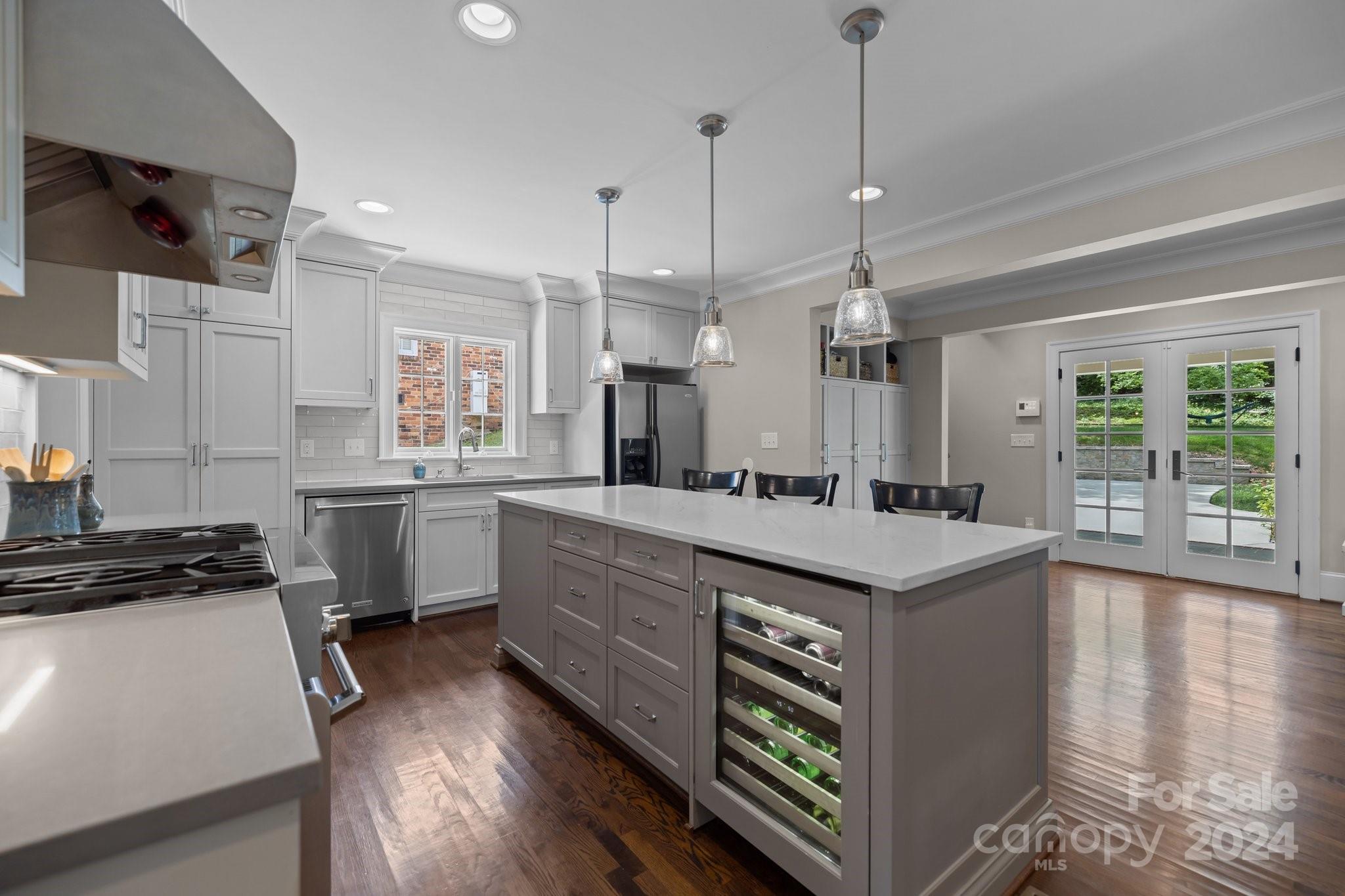 2414 Inverness Road Charlotte, NC 28209 - Photo 12 of 46 a kitchen with a sink stove and wooden floor