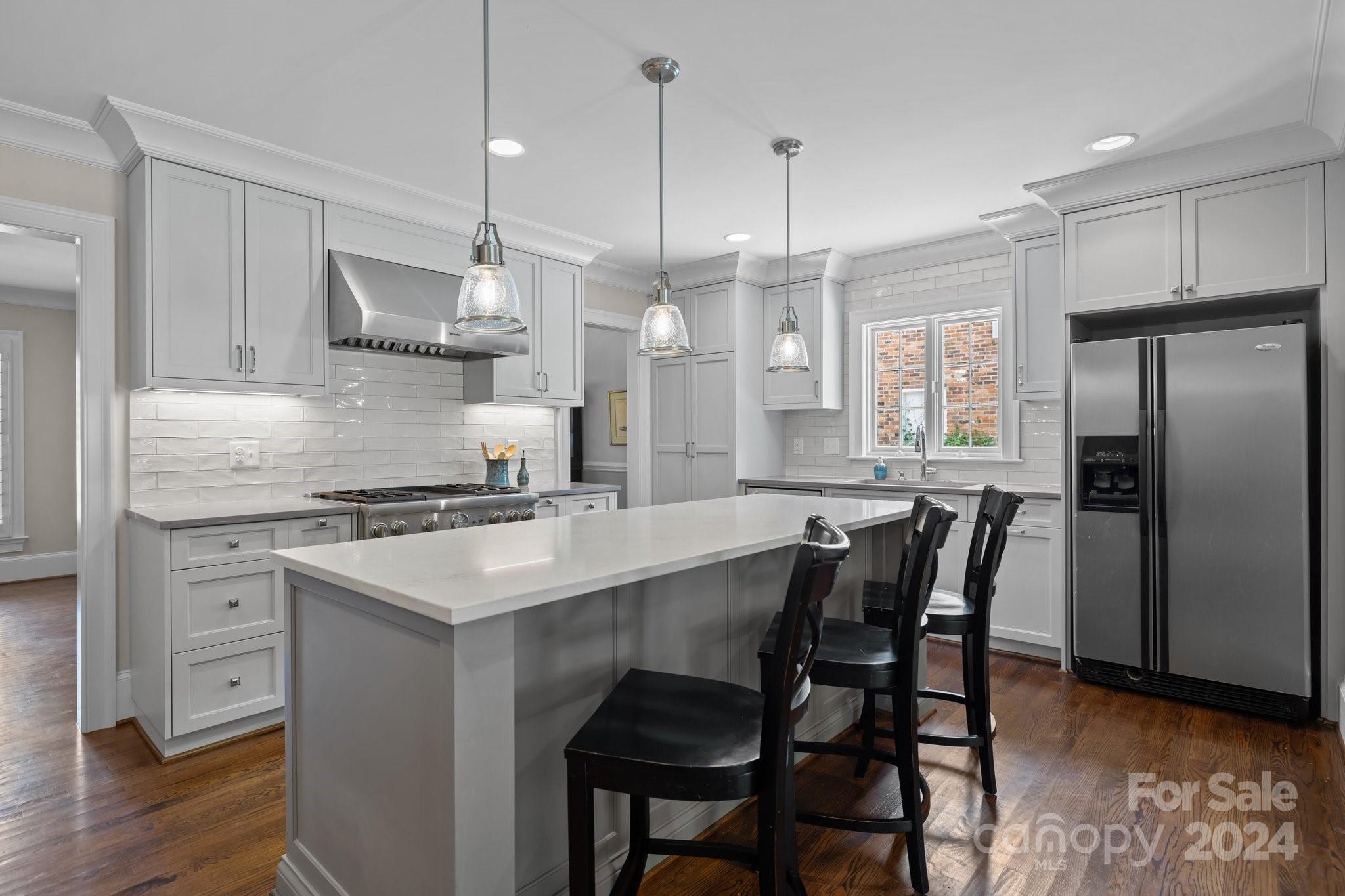 2414 Inverness Road Charlotte, NC 28209 - Photo 13 of 46 a kitchen with stainless steel appliances granite countertop a kitchen island a stove a table and chairs