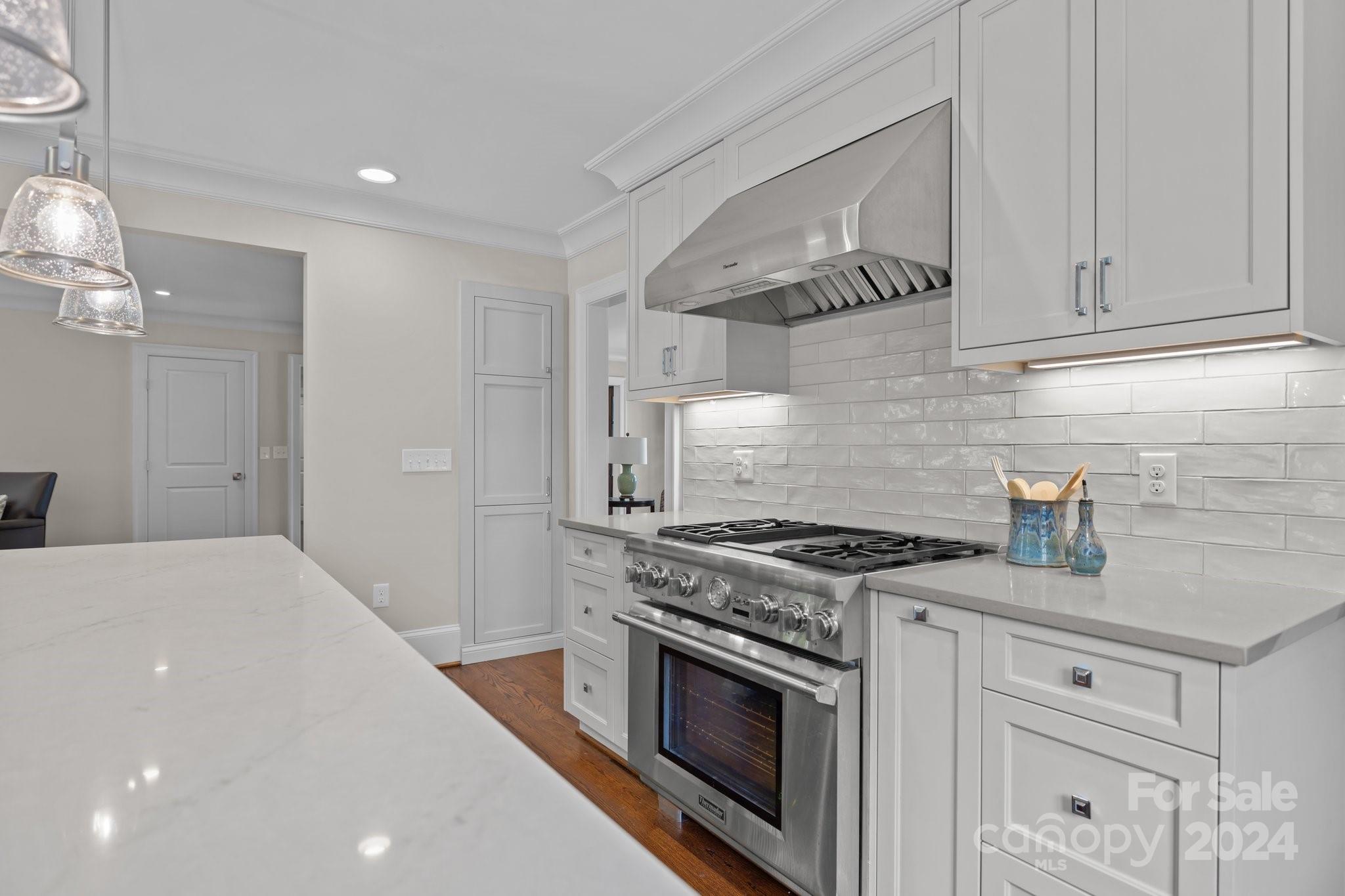 2414 Inverness Road Charlotte, NC 28209 - Photo 16 of 46 a kitchen with granite countertop white cabinets and stainless steel appliances