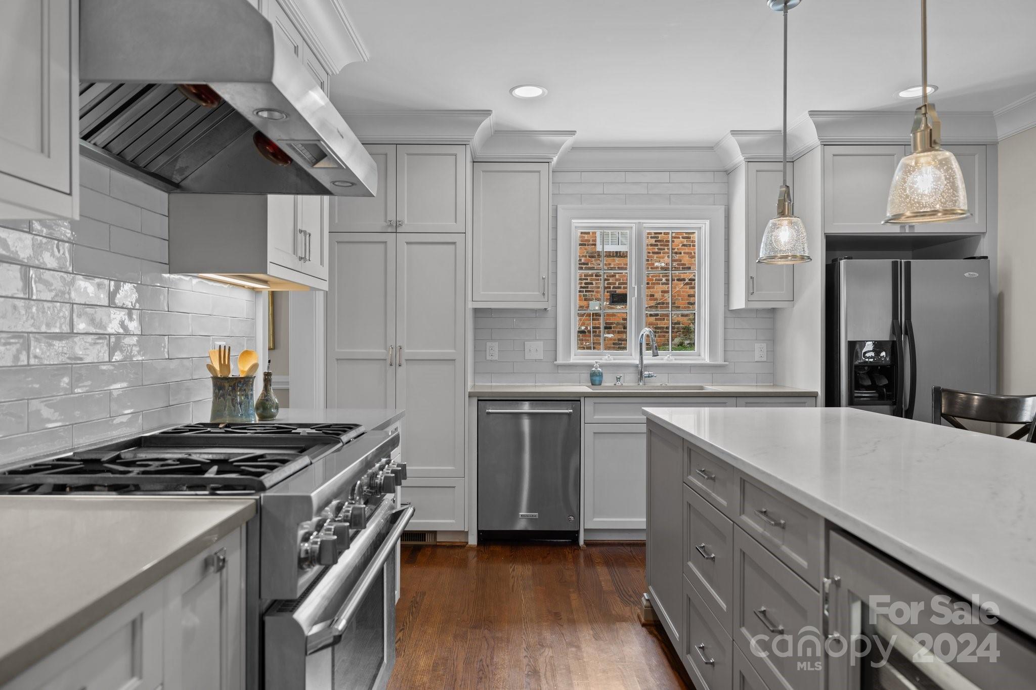 2414 Inverness Road Charlotte, NC 28209 - Photo 17 of 46 a kitchen with a stove a sink and a refrigerator