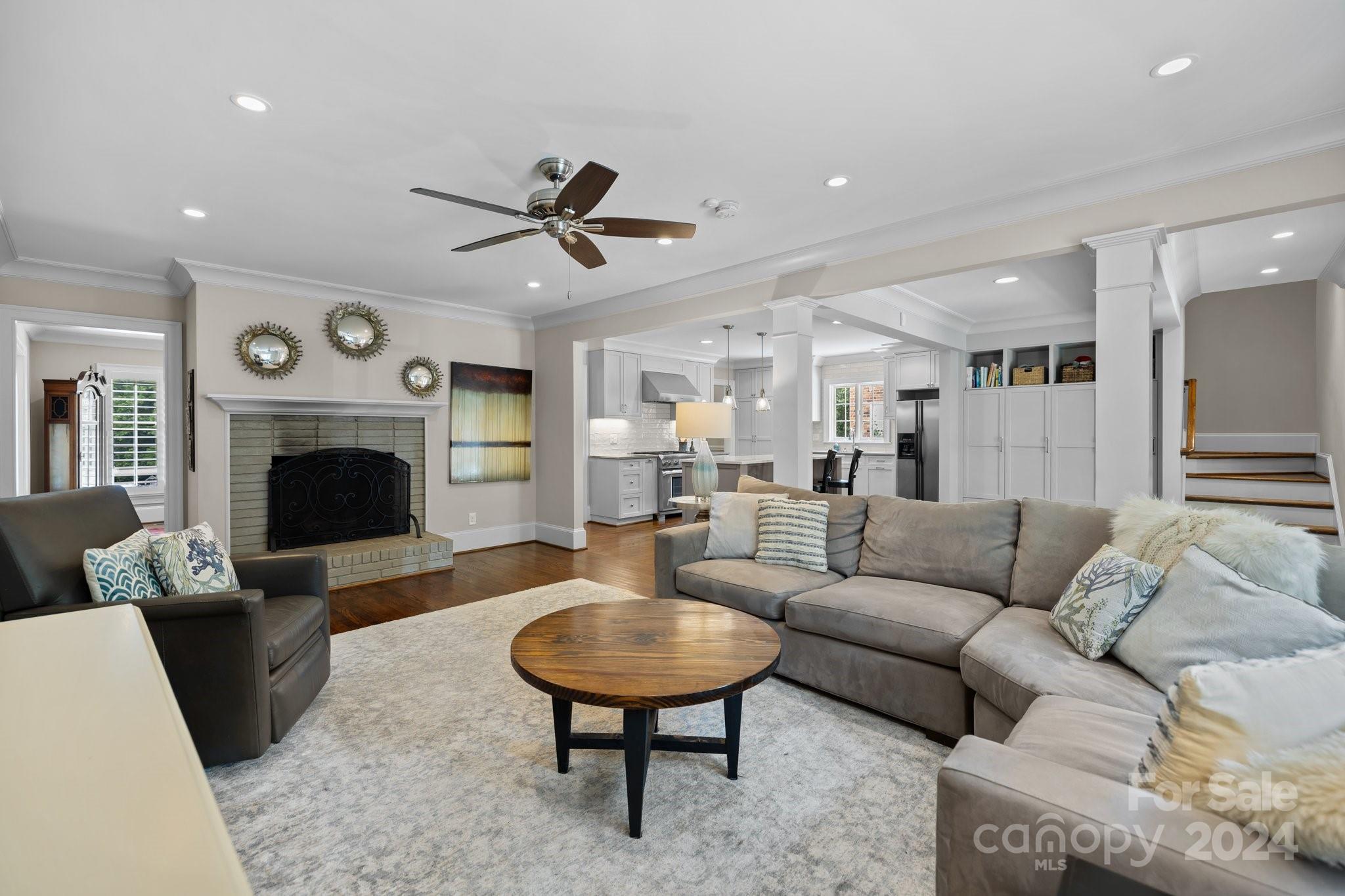 2414 Inverness Road Charlotte, NC 28209 - Photo 19 of 46 a living room with furniture a fireplace and a flat screen tv