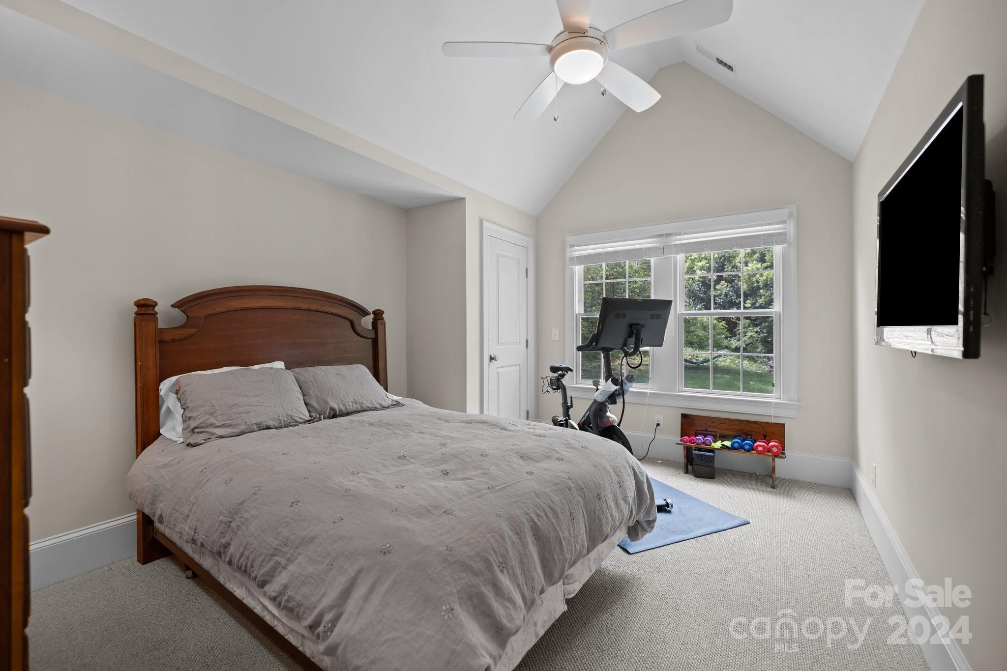 2414 Inverness Road Charlotte, NC 28209 - Photo 30 of 46 a bedroom with a bed and a flat tv screen on dresser