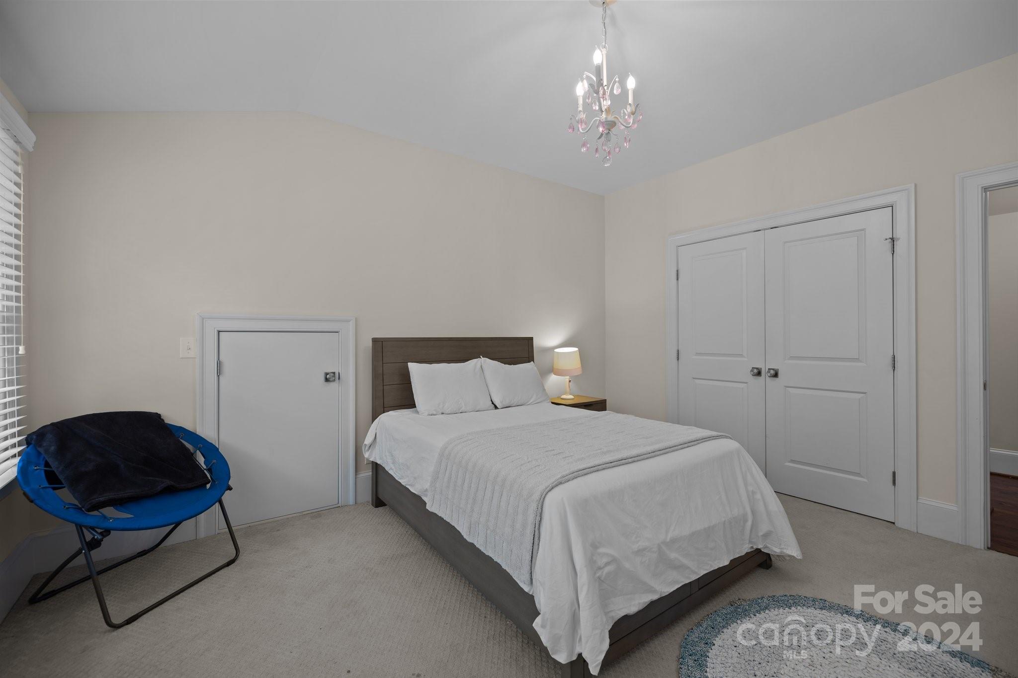 2414 Inverness Road Charlotte, NC 28209 - Photo 33 of 46 a bedroom with a bed mirror and lamp