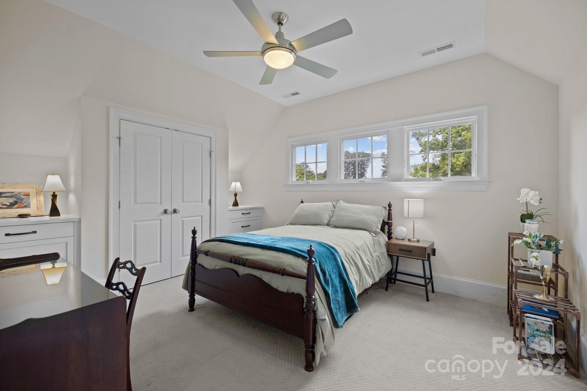 2414 Inverness Road Charlotte, NC 28209 - Photo 34 of 46 a spacious bedroom with a bed and a chandelier