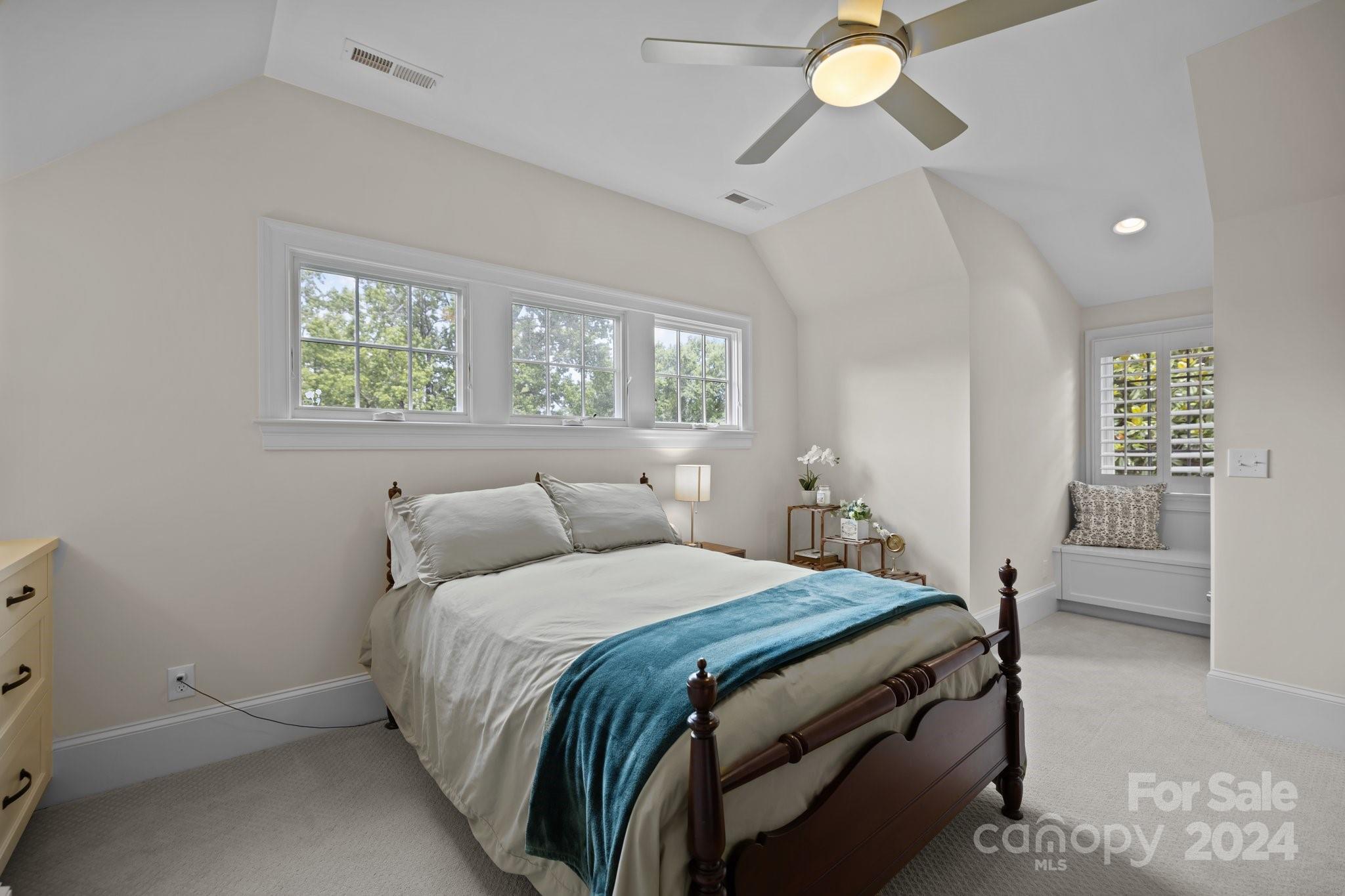 2414 Inverness Road Charlotte, NC 28209 - Photo 35 of 46 a bedroom with a bed and a chandelier