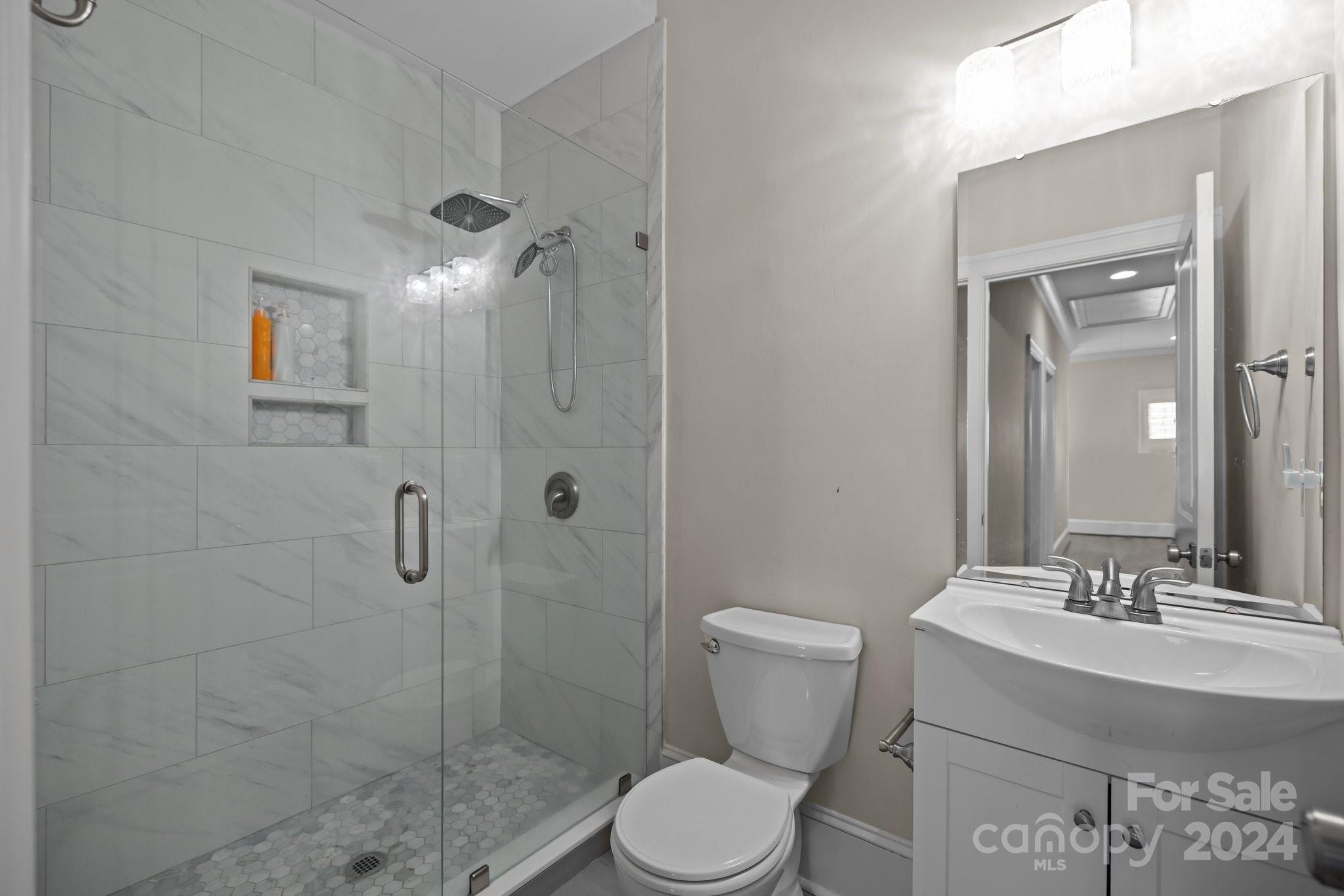 2414 Inverness Road Charlotte, NC 28209 - Photo 37 of 46 a bathroom with a sink toilet and shower