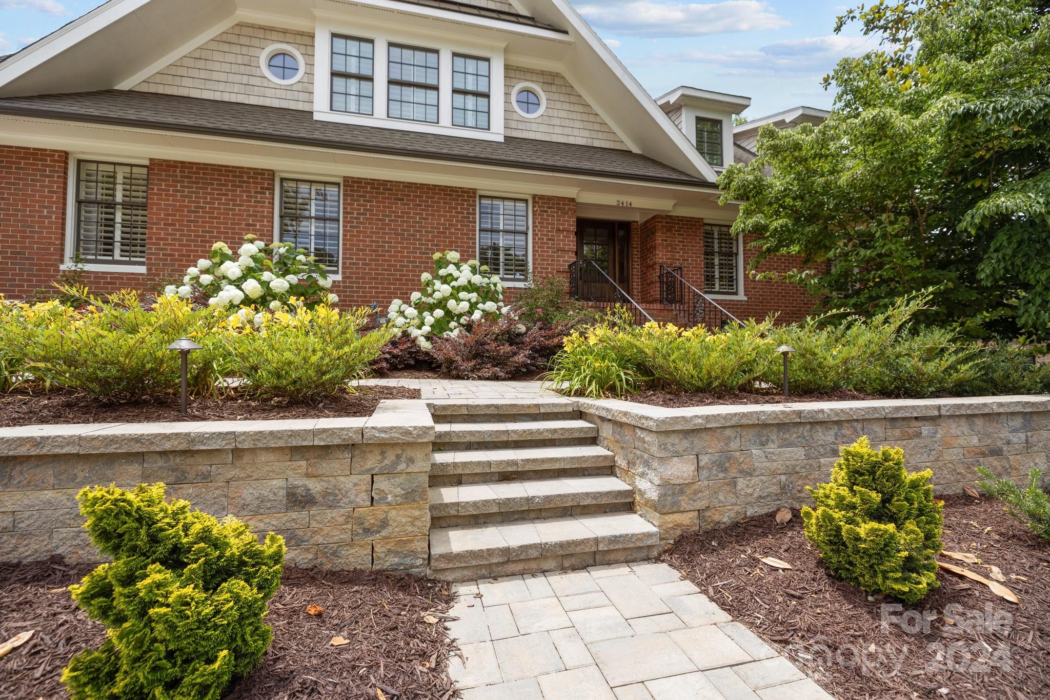 2414 Inverness Road Charlotte, NC 28209 - Photo 4 of 46 a front view of a house with a yard