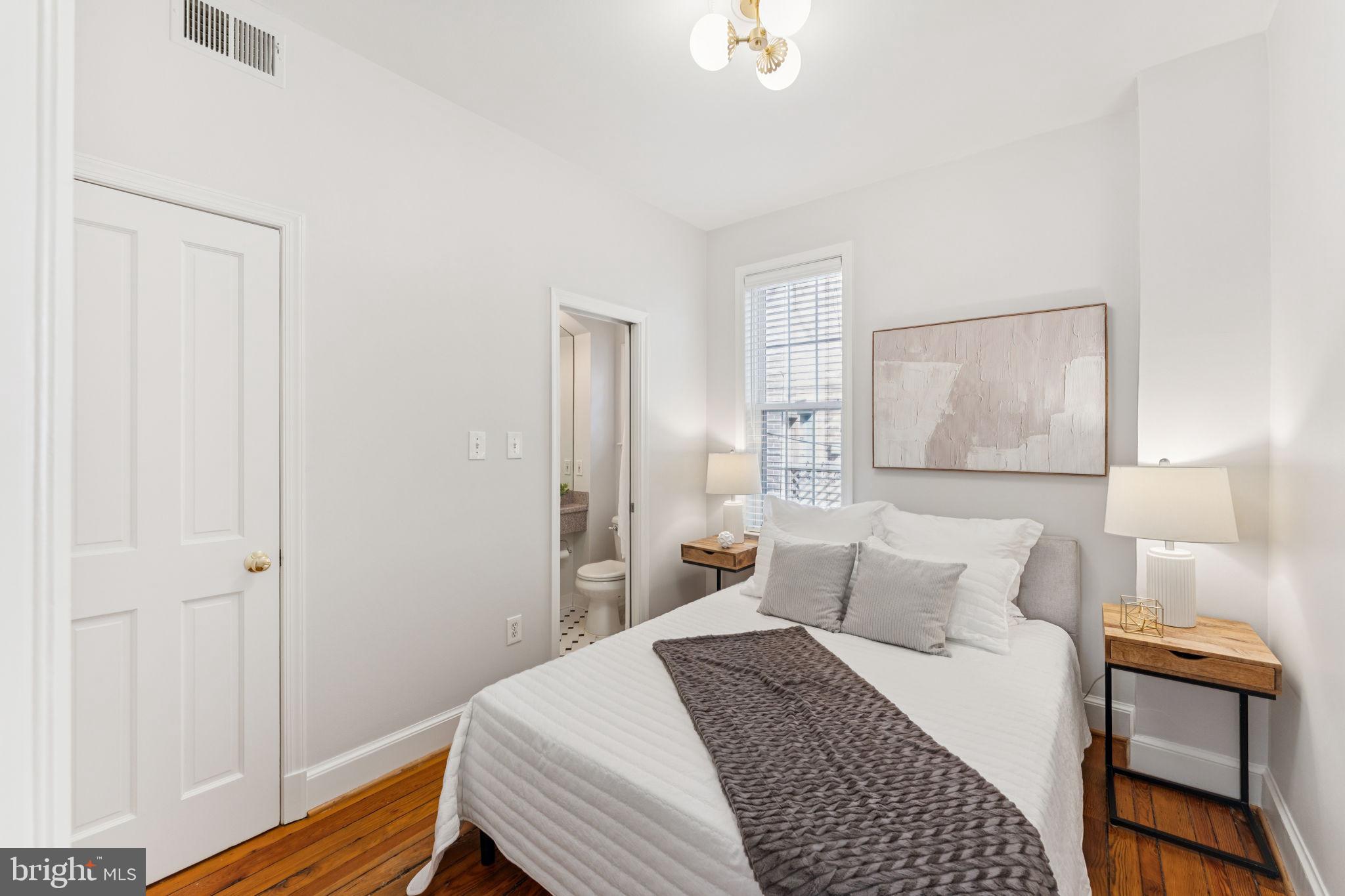 818 Independence Avenue Southeast Washington, DC 20003 - Photo 15 of 28 a bedroom with a bed and wooden floor