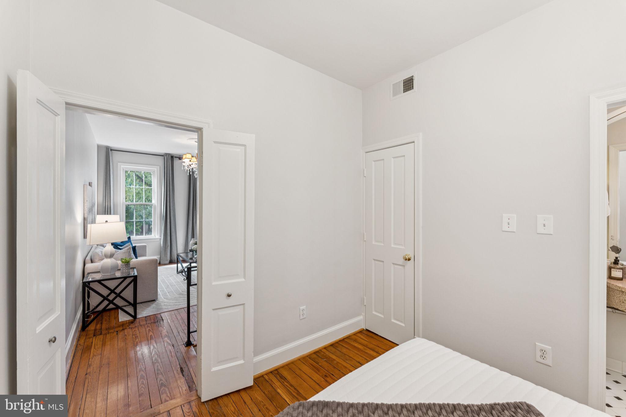818 Independence Avenue Southeast Washington, DC 20003 - Photo 17 of 28 a bedroom with a bed and wooden floor