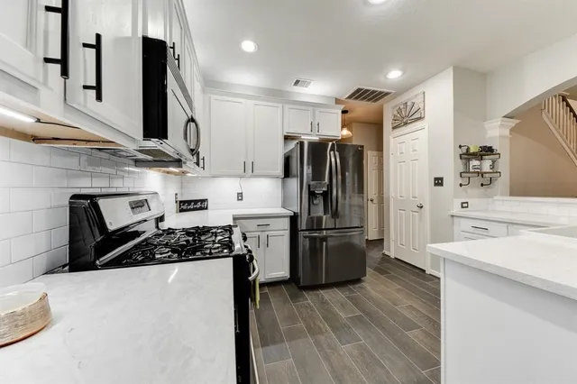 a kitchen with stainless steel appliances a refrigerator stove and sink