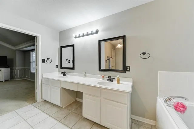 a bathroom with a double vanity sink and a mirror