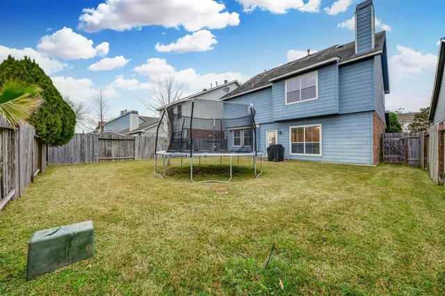 a view of a house with backyard porch and sitting area