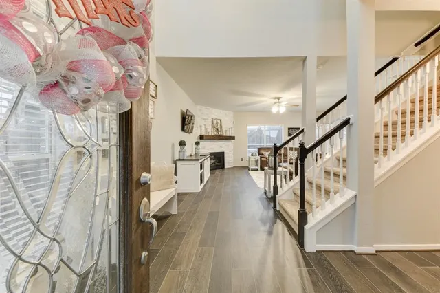 a view of entryway and hall with wooden floor